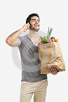 Man carrying a bag full of vegetables