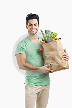 Man carrying a bag full of vegetables