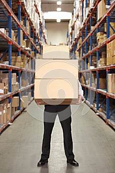 Man Carrying Boxes In Warehouse