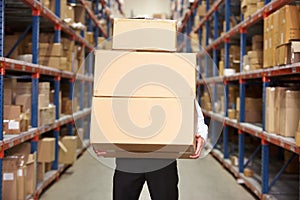 Man Carrying Boxes In Warehouse