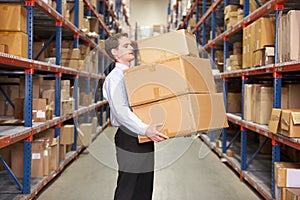 Man Carrying Boxes In Warehouse