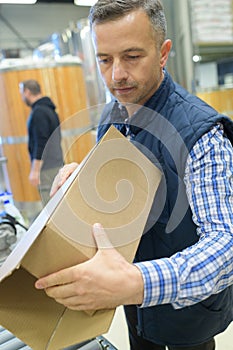 Man carrying cardbox at warehouse