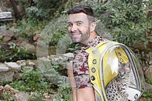 Man carrying cat in transparent backpack