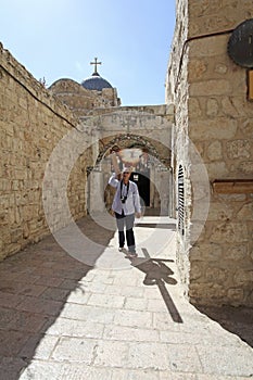 Man carrying cross in Jerusalem Old town. Israel