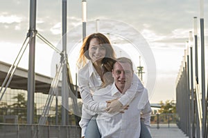 Man carrying girlfriend on his back