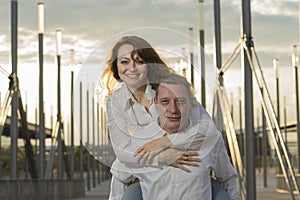 Man carrying girlfriend on his back