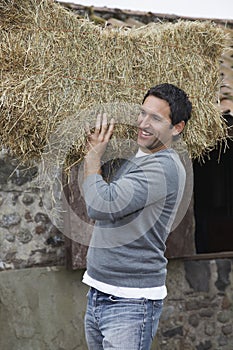 Man Carrying Hay On Shoulders