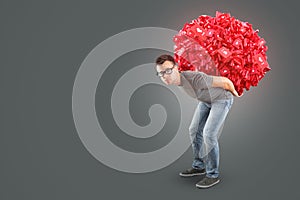 Man carrying a heap of social media Like Symbols on his back