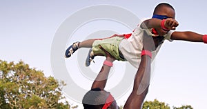 Man carrying his son in costume of superheroes