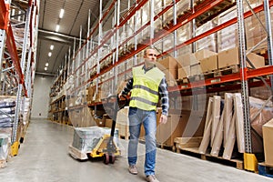 Man carrying loader with goods at warehouse