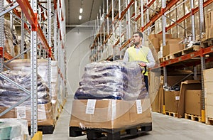 Man carrying loader with goods at warehouse