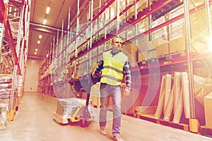 Man carrying loader with goods at warehouse