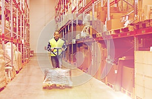 Man carrying loader with goods at warehouse