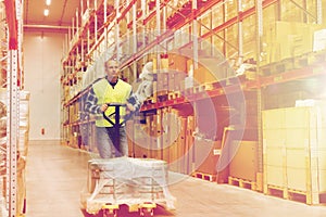 Man carrying loader with goods at warehouse