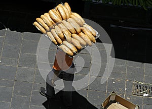 Man carrying loaves of bread