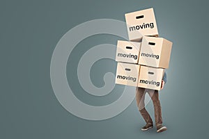 A man is carrying many moving boxes - isolated on a neutral background with copy space