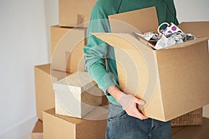 Man Carrying Open Cardboard Box