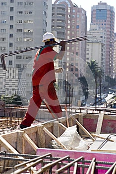 Man Carrying Rebar - Vertical