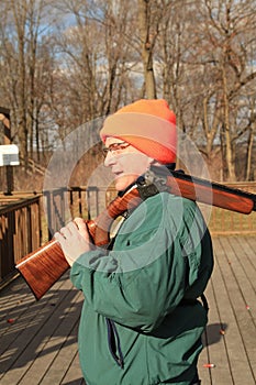 Man carrying shotgun at trap range