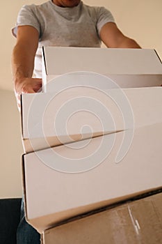 Man Carrying Stack of Moving Boxes