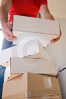 Man Carrying Stack of Moving Boxes
