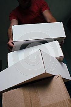 Man Carrying Stack of Moving Boxes