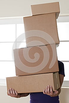 Man Carrying Stacked Boxes