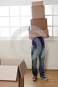 Man Carrying Stacked Boxes