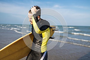 A man carrying a surfboard