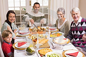 Man carving roast turkey during christmas dinner