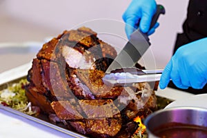 Man Carving Slices Of Roast ham