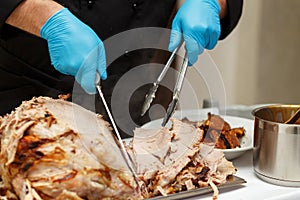 Man Carving Slices Of Roast ham