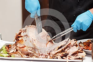 Man Carving Slices Of Roast ham