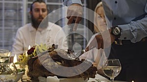 Man carving turkey on holiday dinner