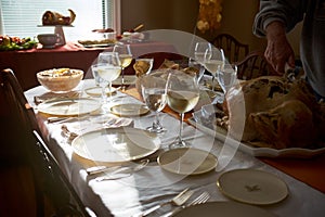 Man carving a turkey at a Thanksgiving table