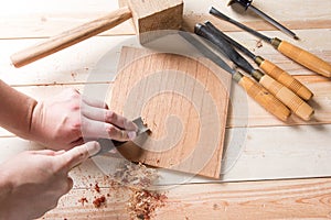 Man carving wood with handtools photo