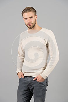 Man in casual tshirt and jeans. Macho with beard on unshaven face. Bearded man with hands in pockets. Confidence and charisma conc