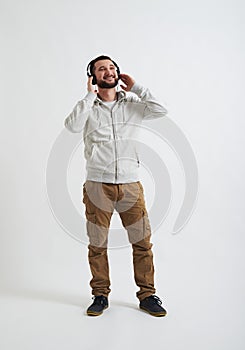 Man in casual wear is listening to music