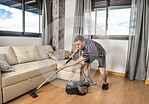 Man vacuuming the living room floor