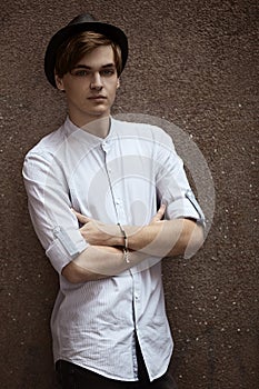 Man casually leaning against the wall