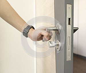 Man catch Door Handles stainless steel on door wood to open