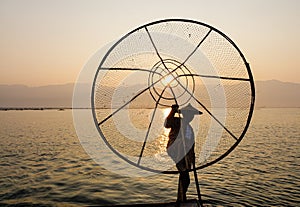 A man catching fish on the lake in Inle, Myanmar