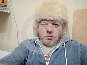 A man of Caucasian appearance in a fur hat.