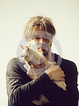Man holding cute cat in arms photo