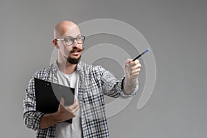 man caucasian teacher professor lecturing while pointing on space isolated on gray background