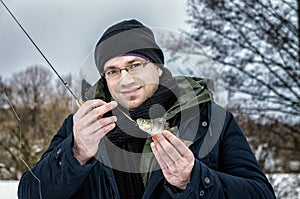 The man caught the first fish on ice fishing