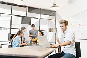 Man celebrate success pose with multi-ethnic diverse team meeting at office. Creative group, business coworker, or college student