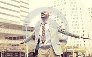 Man celebrates freedom success arms raised looking up