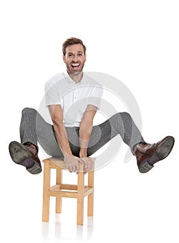 Man celebrates while sitting with legs in the air