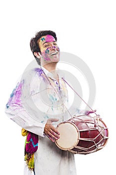 Man celebrating Holi and smiling